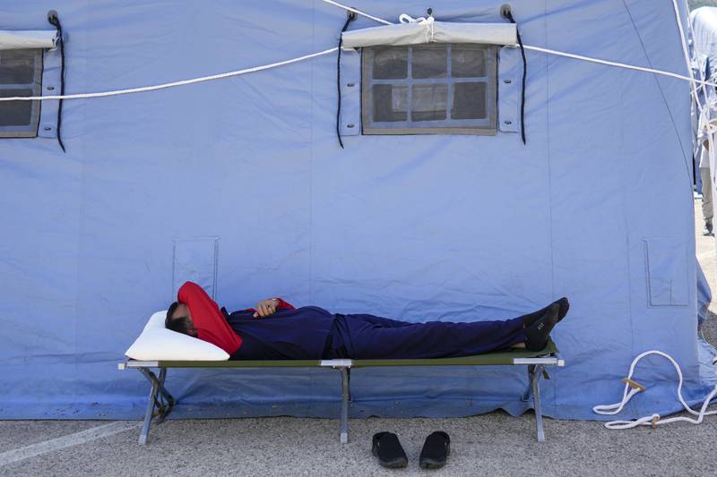 An Afghan refugee rests in the Italian Red Cross refugee camp, in Avezzano. AP