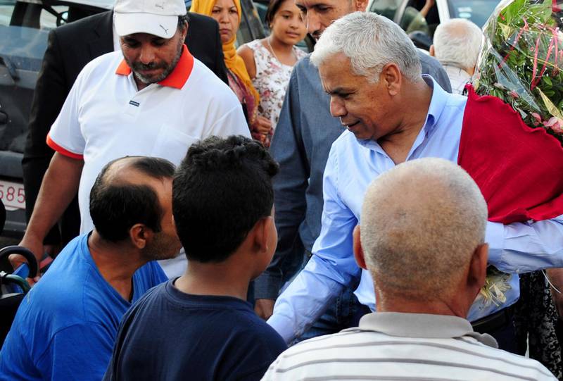 Safi Saïd, a candidate for the upcoming presidential elections, right, greets supporters during an electoral meeting in Ettadhamen City near Tunis, Tunisia.  AP