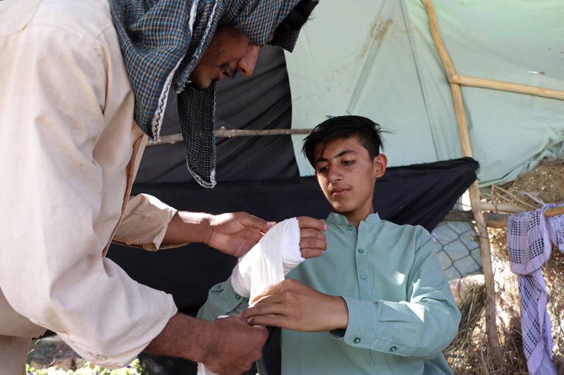 A young Afghan receives medical care after being injured in fighting between the Taliban and security forces in Mazar-e-Sharif. AP