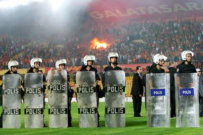 Riot police stand on the pitch as the stands are set on fire by angry Galatasaray fans after a Turkish Super League derby soccer match between archrivals Galatasaray and Fenerbahce in Ali Sami Yen Stadium in Istanbul May 19, 2007.  Fenerbahce won 2-1.  REUTERS/Fatih Saribas  (TURKEY)
Picture Supplied by Action Images *** Local Caption *** 2007-05-19T205926Z_01_FSA13_RTRIDSP_3_SPORT-SOCCER-EUROPE.jpg