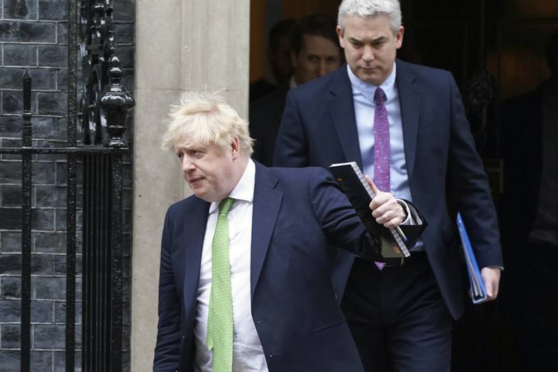 Prime Minister Boris Johnson followed by Downing Street Chief of Staff Steve Barclay, right, outside Downing Street in London.  AP