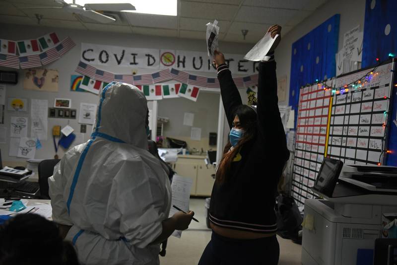 Sanjana Krishnan holds up pieces of a paper while wearing a New Year’s Eve crown as healthcare workers treat patients infected with the coronavirus disease (COVID-19) at United Memorial Medical Center in Houston, Texas, U.S. Reuters