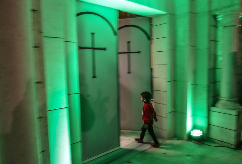 A Christian Palestinian boy enters the Latin Church with his family during midnight Christmas mass, Gaza City.  EPA