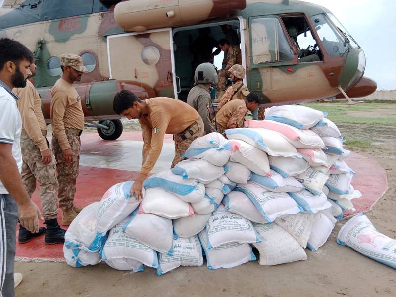 Soldiers load relief goods on to an army helicopter during a relief operation in Sawat, Pakistan. Reuters