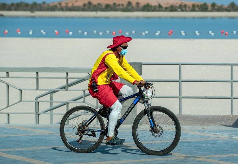 A lifeguard bikes to his spot at Corniche Beach in Abu Dhabi on May 5th, 2021. Victor Besa / The National.
