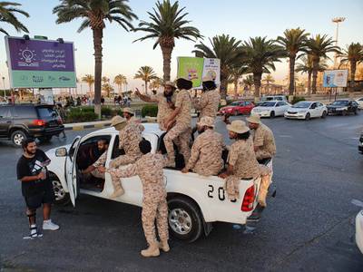 Vehicles of the "Tripoli Brigade", a militia loyal to the UN-recognised Government of National Accord (GNA), parade through the Martyrs' Square at the centre of the GNA-held Libyan capital Tripoli on July 10, 2020. (Photo by Mahmud TURKIA / AFP)