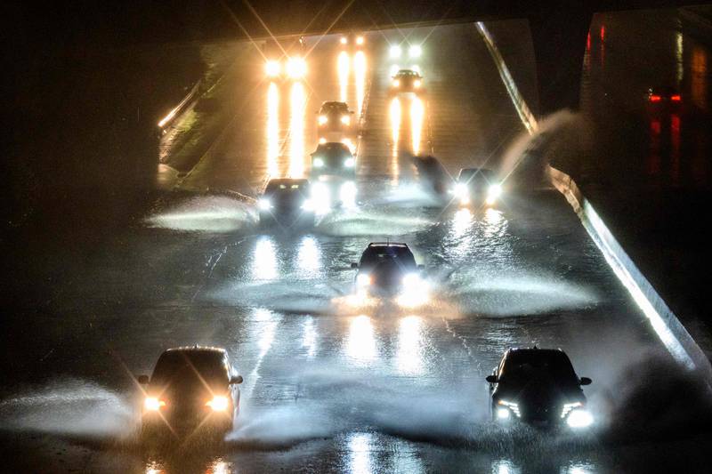 Drivers tackle a waterlogged motorway near San Francisco, California, after a bomb cyclone hit the US state. AFP