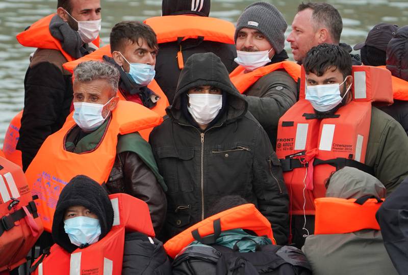 A group of people thought to be migrants arrive in Dover. The surge in the number of people making the risky voyage came amid a spell of mild weather.