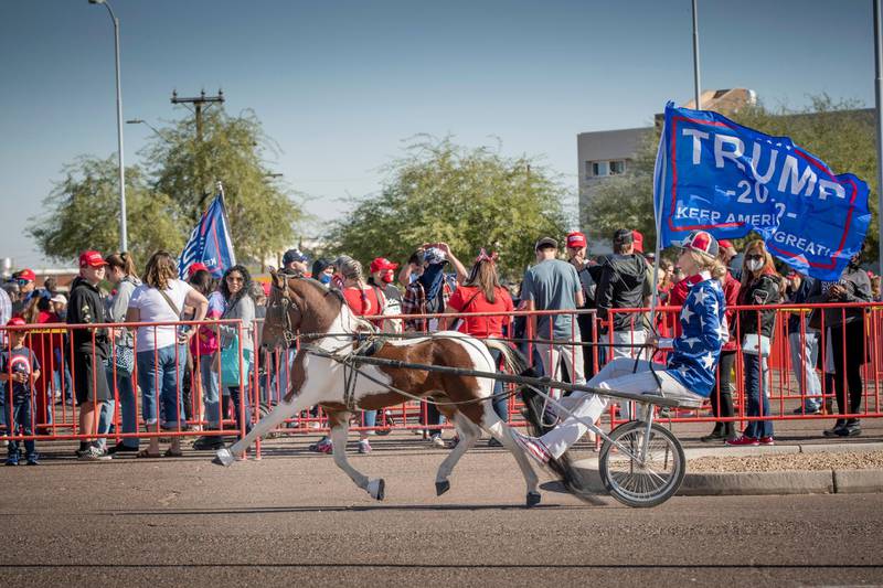 Jessie Dales entertains supporters as they wait in line to enter the venue where US President Donald J. Trump will speak on a campaign stop, outside the venue at Goodyear Airport in Phoenix, Arizona. EPA