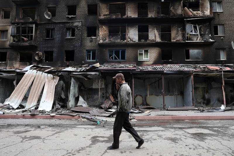 A man passes destroyed buildings in the Ukrainian town of Siversk. AFP