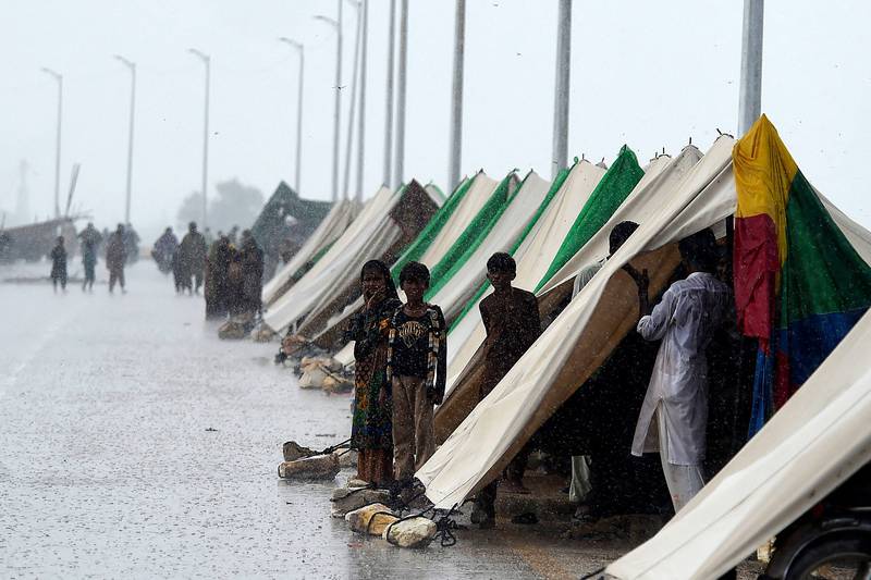 Tents set along a road provide temporary shelter during monsoon rains in Sukkur, Sindh province. AFP
