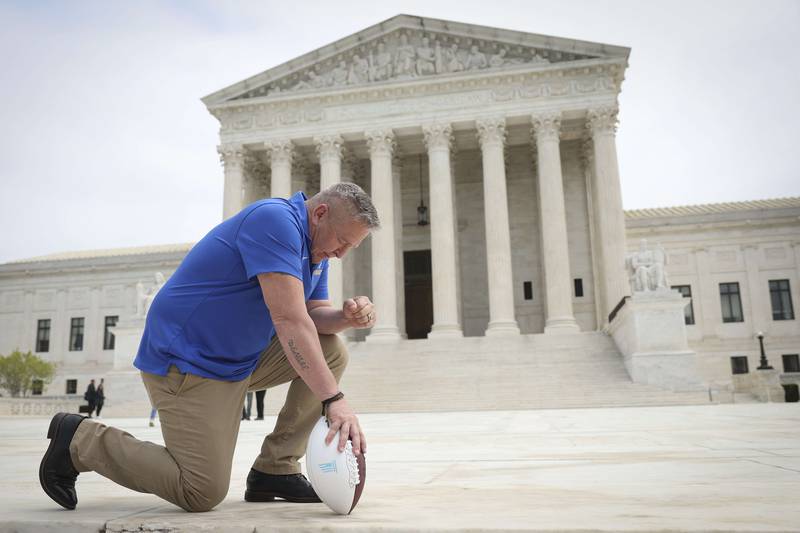 Former Bremerton High School assistant American football coach Joe Kennedy takes a knee in front of the US Supreme Court in April. AFP