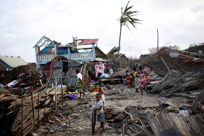 Residents stand among destroyed houses following Cyclone Batsirai in Mananjary, Madagascar. Reuters