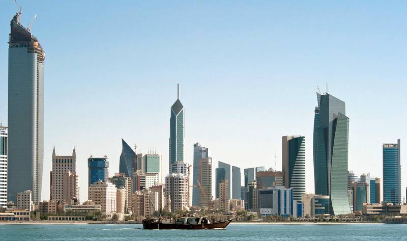 A fishing boat passes in front of the Kuwait City skyline September 11, 2010. REUTERS/Stephanie McGehee (KUWAIT - Tags: CITYSCAPE)