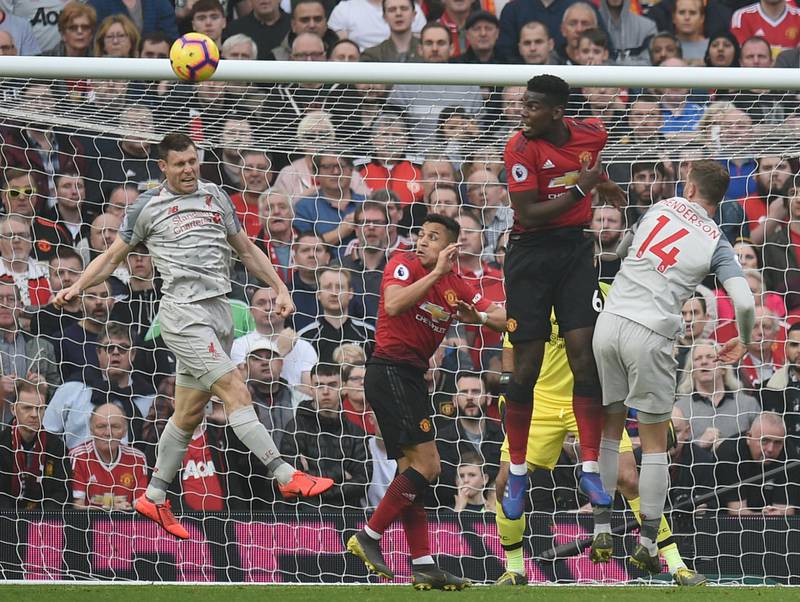 (L-R) Liverpool's English midfielder James Milner, Manchester United's Chilean striker Alexis Sanchez, Manchester United's French midfielder Paul Pogba and Liverpool's English midfielder Jordan Henderson go up for a header during the English Premier League football match between Manchester United and Liverpool at Old Trafford in Manchester, north west England, on February 24, 2019. (Photo by Oli SCARFF / AFP) / RESTRICTED TO EDITORIAL USE. No use with unauthorized audio, video, data, fixture lists, club/league logos or 'live' services. Online in-match use limited to 120 images. An additional 40 images may be used in extra time. No video emulation. Social media in-match use limited to 120 images. An additional 40 images may be used in extra time. No use in betting publications, games or single club/league/player publications. / 