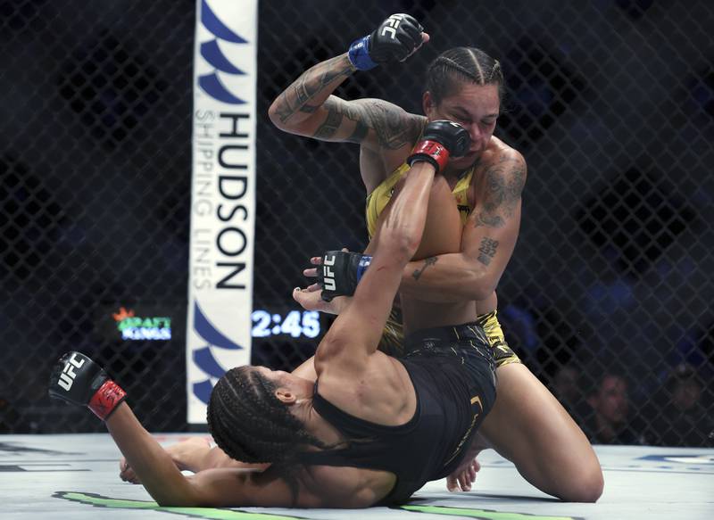 Julianna Pena lands a blow to the face of Amanda Nunes during their bantamweight title bout at UFC 277. AP