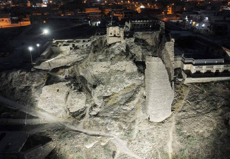 The illuminated ruins of the 13th century palace Qara Serai – the Black Palace – of the Zengid Turkoman Sultan Badr Al Din Lu'lu', in Iraq's northern city of Mosul, on the seventh anniversary of the city's fall to ISIS. AFP