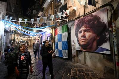A mural of Diego Maradona is seen in the city centre as fans of Napoli celebrate their side winning the Serie A title. Getty Images