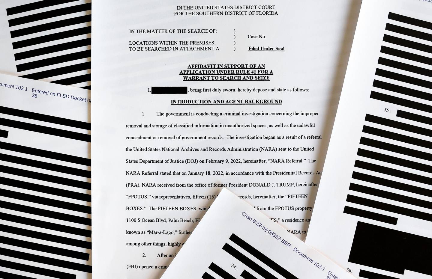 Pages from the government’s released version of the FBI search warrant affidavit for former US President Donald Trump's Mar-a-Lago estate on August 27, in California. Getty
