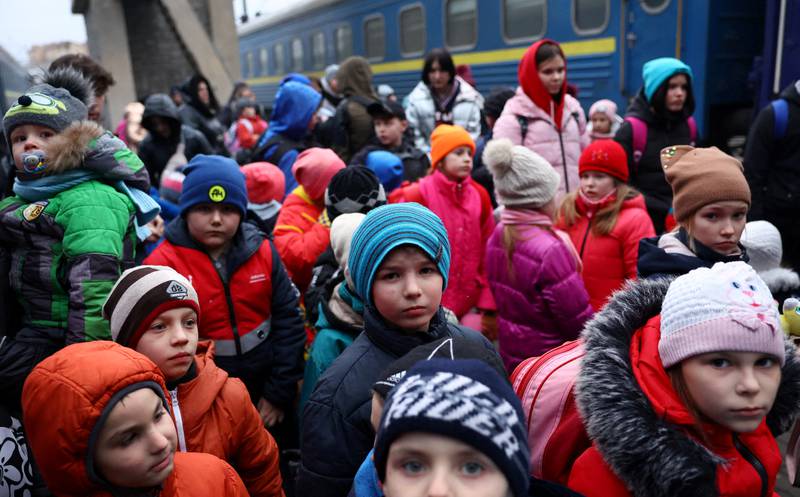 A group of children from an orphanage in Zaporizhzhia wait to board a bus to Poland after fleeing the Russian onslaught, Ukraine, March 5, 2022.    Reuters
