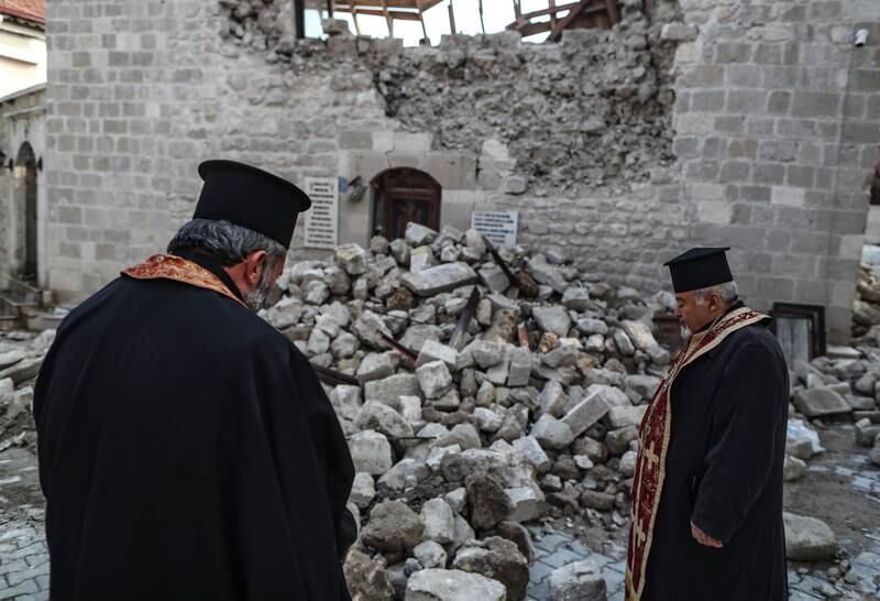 Priests stand at the collapsed Virgin Mary Greek Orthodox Church in Hatay, in Turkey, last month. EPA