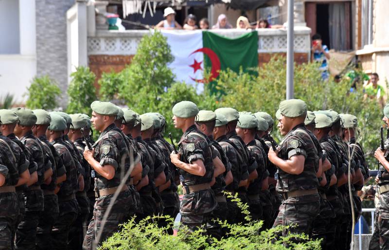 Algerian soldiers parade down a street in Algiers. AFP