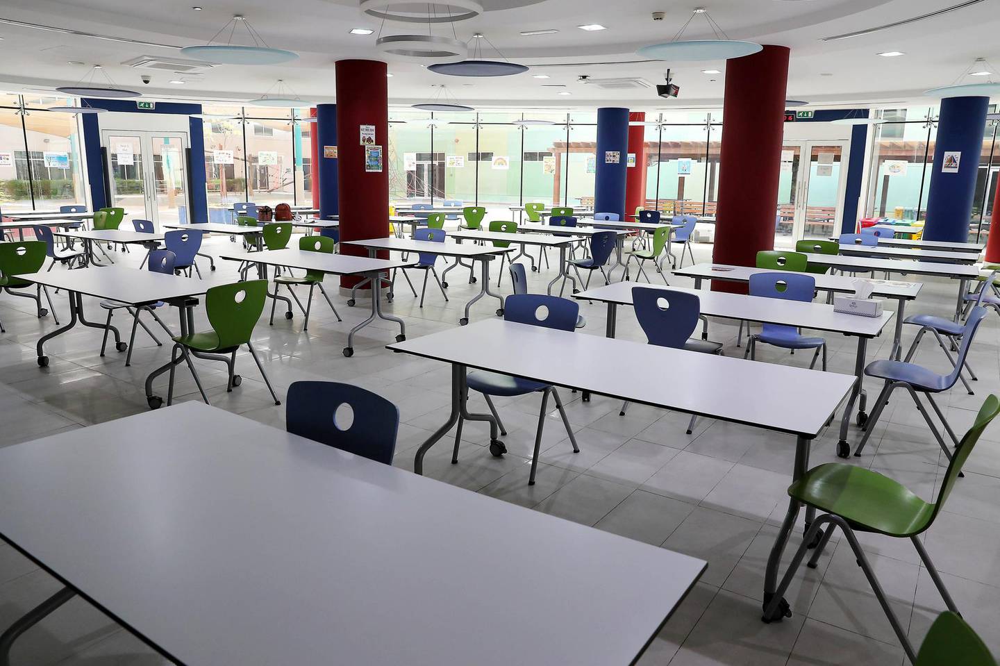 DUBAI, UNITED ARAB EMIRATES , August 9 – 2020 :- View of the canteen area and around 2 meters distance on the sitting table at the Dubai British School in Jumeirah Park in Dubai. New Covid safety setup in different areas of the school such as 1.5 meter distance on the table in the class room, hand sanitizer, safety message, social distancing stickers pasted on the floor, thermal cameras will be installed at the entrance of the school. School will open on 30th August. (Pawan Singh / The National) For News/Online/Instagram. Story by Kelly