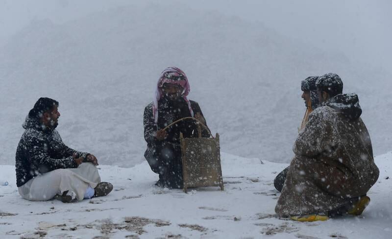 People enjoy a moment in the snow in Tabuk. Photo: SPA