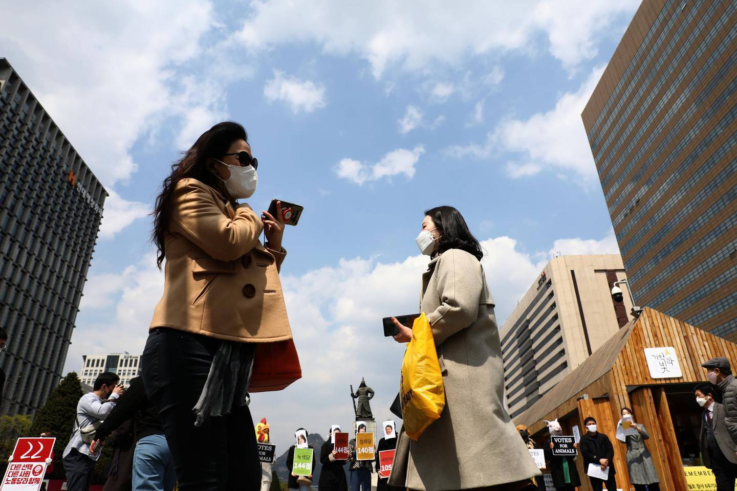 SEOUL, SOUTH KOREA - APRIL 10: South Koreans wear masks walk along the steet as South Koreans take measures to protect themselves against the spread of coronavirus (COVID-19) on April 10, 2020 in Seoul, South Korea. Preliminary voting has started at local polling stations across South Korea prior to the primary Presidential election on April 10. South Korea has called for expanded public participation in social distancing, as the country witnesses a wave of community spread and imported infections leading to a resurgence in new cases of COVID-19. According to the Korea Center for Disease Control and Prevention, 27 new cases were reported. The total number of infections in the nation tallies at 10,450. (Photo by Chung Sung-Jun/Getty Images)