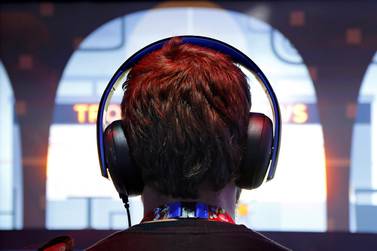A gamer wears headphones while playing a game. Use of headphones is raising fears about ear damage. Jonathan Alcorn / Reuters
