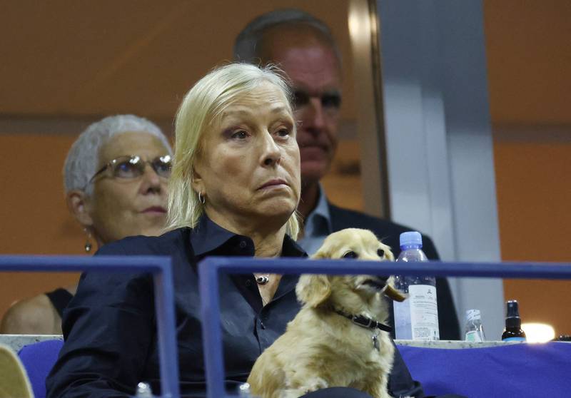 Former tennis star Martina Navratilova and her dog Lulu watch the US Open semi-final. Reuters
