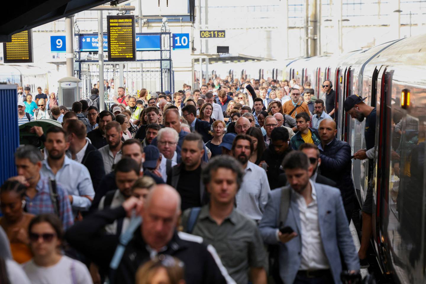 Crowds of passengers get off a train at Waterloo Station in central London. Reuters