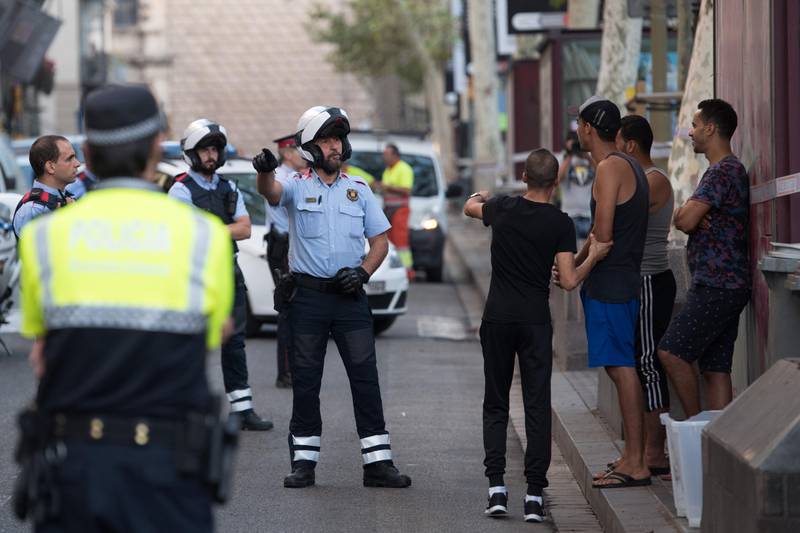 BARCELONA, SPAIN - AUGUST 18:  Police officers check the identity of a group of men on Las Ramblas following yesterday's terrorist attack, on August 18, 2017 in Barcelona, Spain. Thirteen people were killed and dozens injured when a van hit crowds in the Las Ramblas area of Barcelona on Thursday. Spanish police have also killed five suspected terrorists in the town of Cambrils to stop a second terrorist attack.  (Photo by Carl Court/Getty Images)