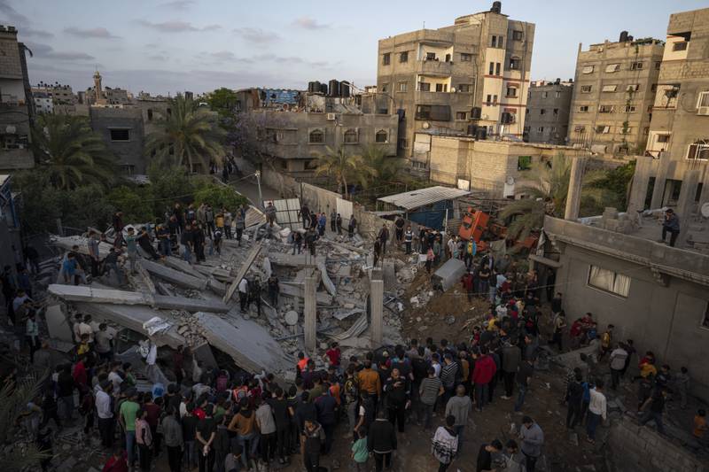 Palestinians inspect the rubble of Islamic Jihad member Zeyad Selmi's house after it was hit by an Israeli airstrike in Gaza City, Saturday. AP