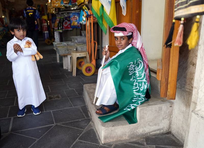A boy draped in a Saudi Arabia flag. PA