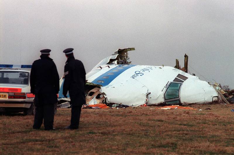 Police officers examine the wreckage.