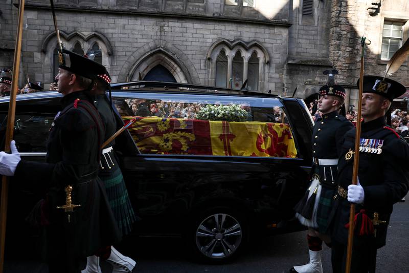 The hearse carrying the coffin of the queen travels slowly on the Royal Mile in Edinburgh. Reuters