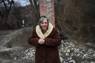 A woman at a checkpoint on the road to Kyiv after her evacuation from a nearby town.  AFP