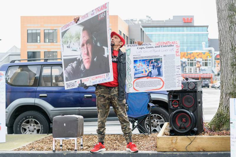 Omar Nabi, whose father Daoud Nabi was killed at Al Noor Mosque, holds posters in front of Christchurch High Court. Getty Images