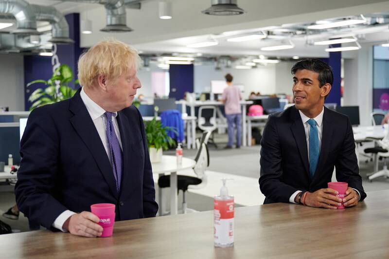 Mr Johnson and Mr Sunak visit the headquarters of Octopus Energy in London in October 2020. Getty
