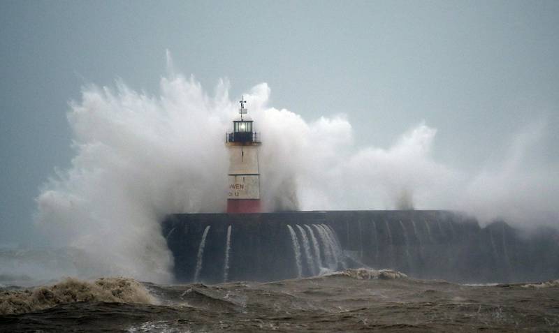 Waves crash over Newhaven Lighthouse on the south coast of England, as Storm Ciara swept over the country.   AFP