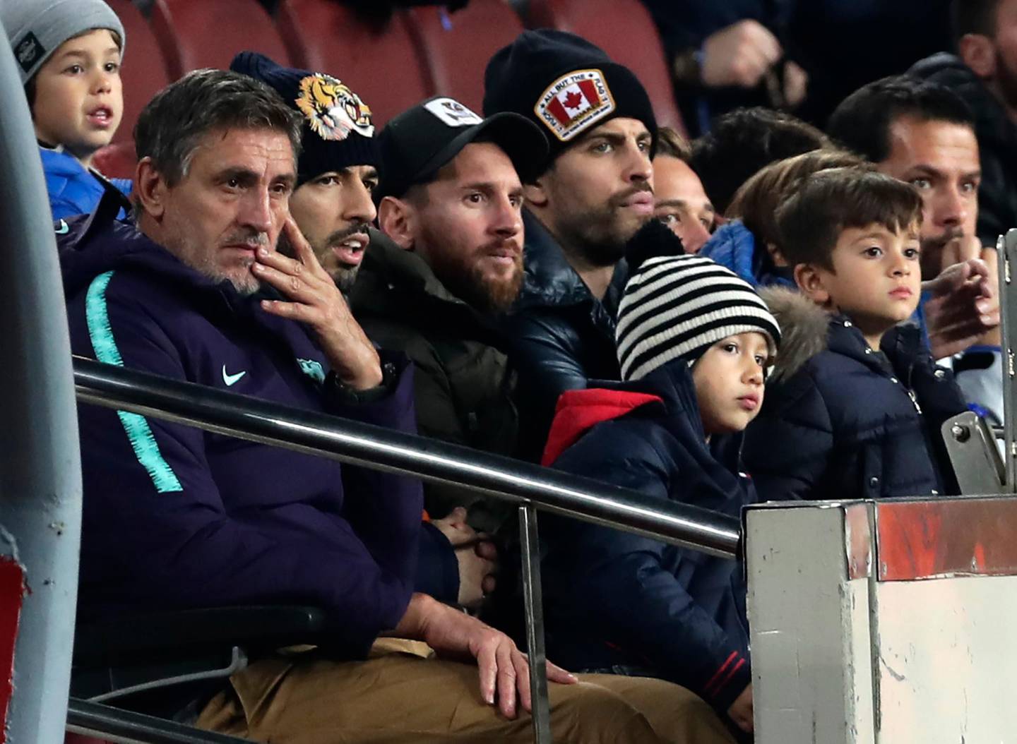 FC Barcelona's Lionel Messi, third left, Luis Suarez, second left, and Gerard Pique, center right, sit is the stands prior of a Spanish Copa del Rey soccer match between FC Barcelona and Cultural Leonesa at the Camp Nou stadium in Barcelona, Spain, Wednesday, Dec. 5, 2018. (AP Photo/Manu Fernandez)