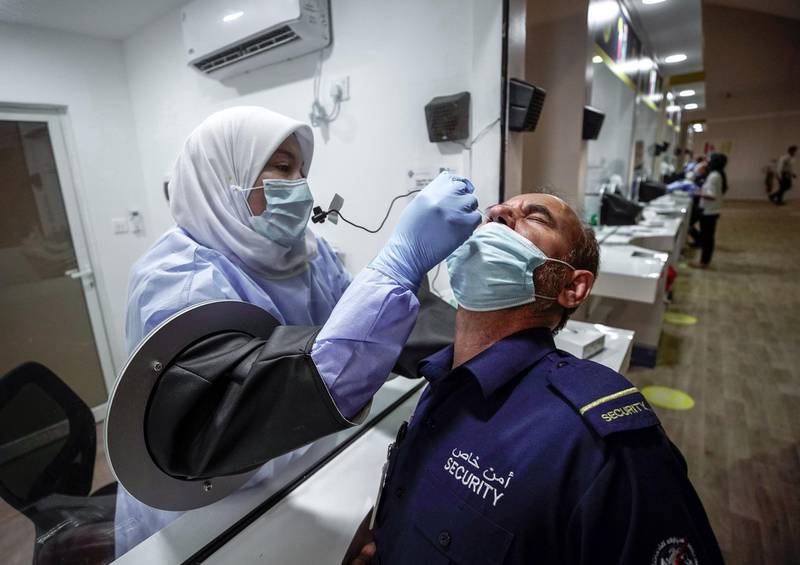 Abu Dhabi, United Arab Emirates, May 6, 2020. the new Ambulatory Healthcare Services, a SEHA Health System Facility, National Screening Project in Mussafah Industrial Area in Abu Dhabi.  --  A swab test is conducted on a security guard.
Victor Besa / The National
Section:  NA
Reporter:  Nick Webster