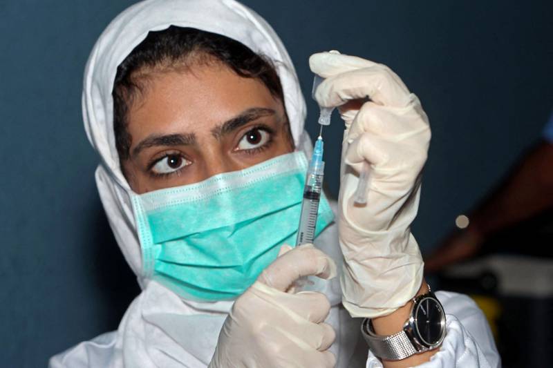 A healthcare worker prepares a dose of the Pfizer/BioNTech Covid-19 vaccine at the Sultan Qaboos Sports Complex in Oman's capital Muscat. AFP