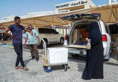 Abu Dhabi, United Arab Emirates, June 27, 2019.   Mirfa (west of ad)  to find out what people think about ghadan.  -- The Mirfa Fish Market.  A lady has her fish delivered to her SUV.Victor Besa/The NationalSection:  NAReporter:Anna Zacharias