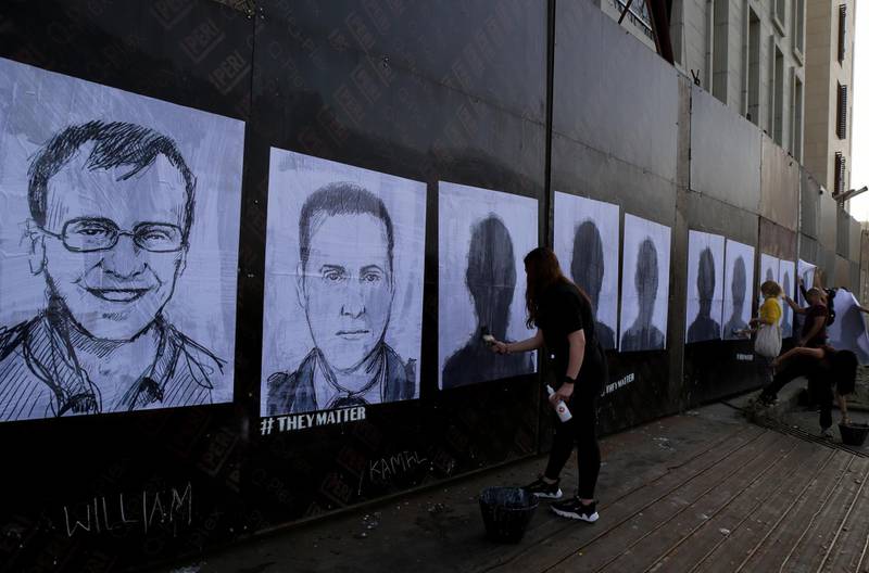 Activists hang portraits of the victims of the August 4 Beirut port explosion on a wall in the Lebanese capital. Artist Brady Black, in partnership with the Art of Change organisation, drew more than 200 caricatures of the victims. EPA