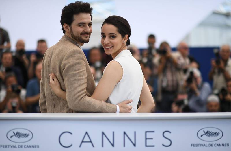 TOPSHOT - Egyptian director A.B Shawky (L) and producer Dina Emam pose on May 10, 2018 during a photocall for the film "Yomeddine" at the 71st edition of the Cannes Film Festival in Cannes, southern France.  / AFP / Anne-Christine POUJOULAT
