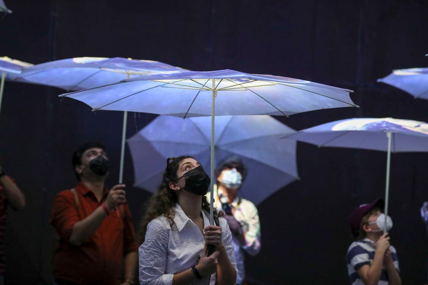 White umbrellas turn into projection screens at the Netherlands Pavilion. Khushnum Bhandari / The National

