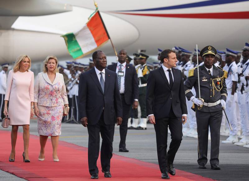 Emmanuel Macronis greeted by Ivory Coast's President Alassane Ouattara  next to their wives Brigitte Macron  and Dominique Folloroux-Ouattara  in Abidjan.  AFP