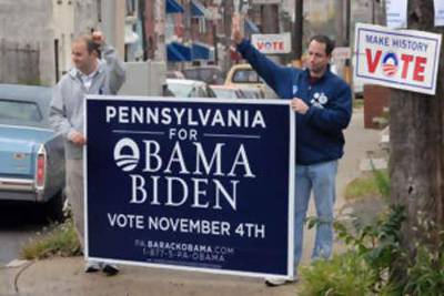 PHILADELPHIA - NOVEMBER 4: Jason Derker (L), of Stamford, Connecticut and Geoff Schneider (R), of Wilton, Connecticut hold a sign supporting Obama as they walk through a neighborhood on Election Day on November 4, 2008 in Philadelphia, Pennsylvania. After nearly two years of presidential campaigning, U.S. citizens go to the polls today to vote in the election between Democratic presidential nominee U.S. Sen. Barack Obama (D-IL) and Republican nominee U.S. Sen. John McCain (R-AZ).   William Thomas Cain/Getty Images/AFP== FOR NEWSPAPERS, INTERNET, TELCOS & TELEVISION USE ONLY == *** Local Caption ***  635827-01-08.jpg